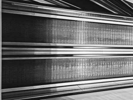 Shining metal modern escalator details, two-lane modern empty escalator stairs up and down in office building, subway station or shopping mallの写真素材