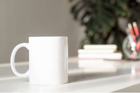 White cup of tea on white table in officeの写真素材