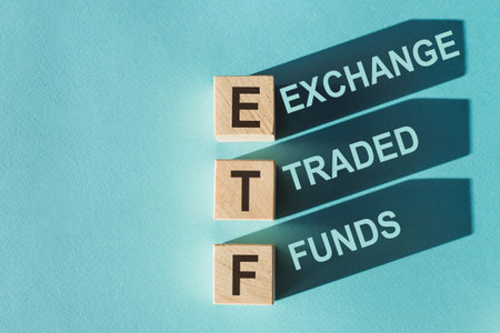 Tile letter on red rack in word ETF (abbreviation of Exchange Traded Fund) on wood backgroundの写真素材