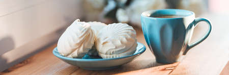 Cup of coffee with marshmallows and on a wooden tableの写真素材