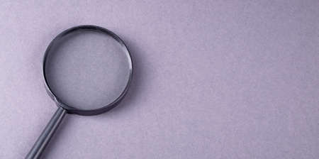 Concept of search and question with magnifying glass, banner with gray bakcgroundの写真素材