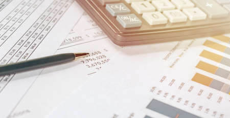 Calculator and pen on financial document, financial conceptの写真素材