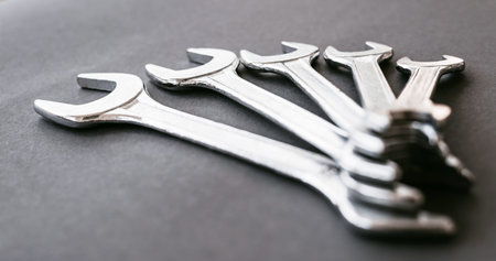 Set of the stainless steel wrench on dark background