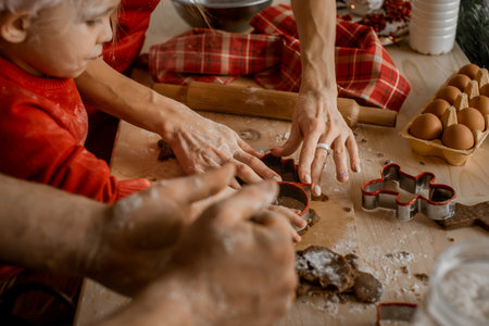 Family together cut out cookies from the dough, Close up of table. Side view. Christmas concept and cooking festive home-cooked meals with children.の写真素材