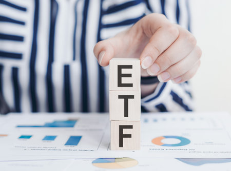 ETF investor. Acronym on wood dices in investors hand.の写真素材