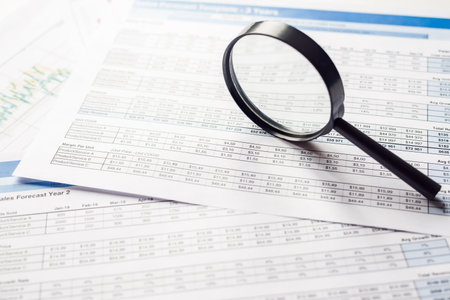 Checking financial reports. Documents and magnifying glass