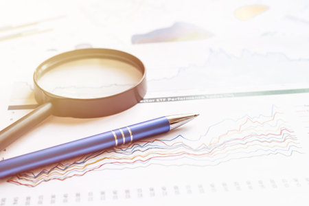 graphs and magnifier. Analyzing finances.