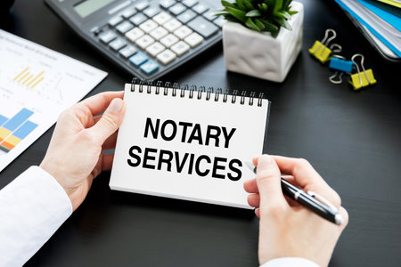 NOTARY SERVICES text on paper notepad with pen in hands of business woman. business conceptの写真素材