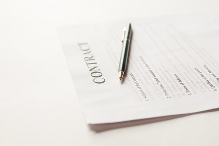 Fastened pages with legal documents and pen on white background.の写真素材