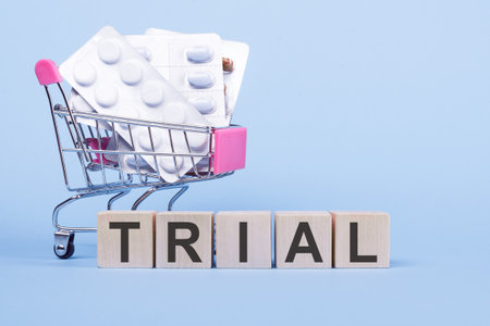 Trial word from wooden cubes on blue background, medical concept.の写真素材