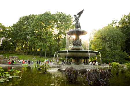 Bethesda fountain in Central park, backlit by late afternoon sun with many people behind it - July 17, 2016, Central park, New York City, NY, USAのeditorial素材