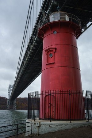 Little red lighthouse under Washington Bridge on dark autum day - New York City