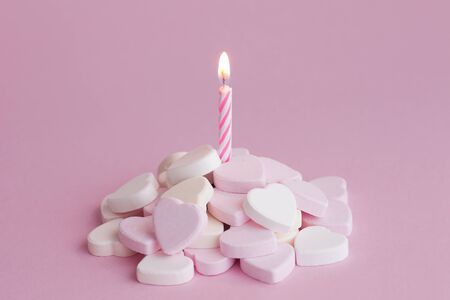 Birthday candle and sugar heartsの写真素材