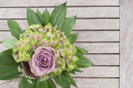 Hydrangea and rose bouquet on wooden table の写真素材