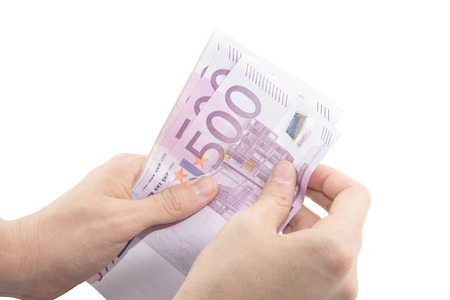 Isolated hands counting five hundred Euro banknotesの写真素材