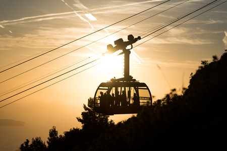 Silhouette of a cable car to the top of Srd mountain in Dubrovnik, Croatia during sunsetの写真素材