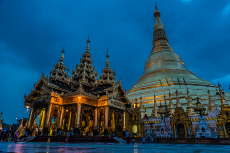View of golden Shwedagon pagoda in the evening illuminated with light, Yangon, Myanmarのeditorial素材