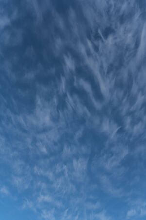 Cloudscape on a bright sunny day with light clouds on the skyの写真素材