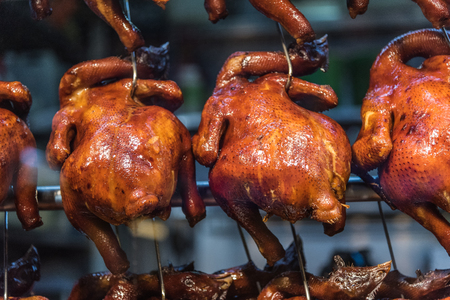 Closeup shot on roast chicken hanging in a hawker stallの写真素材