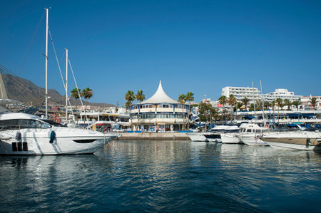 Costa Adeje, Tenerife, Canary Islands, Spain - July 6, 2018: view from the ocean of the popular resort of Las Americas for its port restaurants, pubs and bars, entertainment and night life venues.のeditorial素材