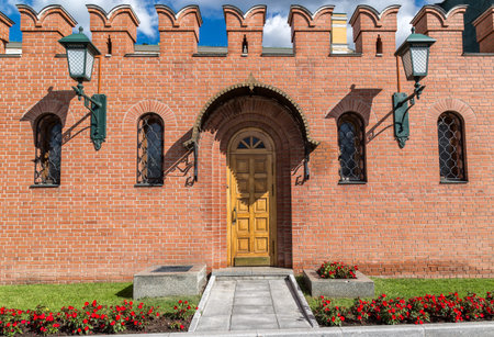 Door in the wall with two lanterns on each side in Moscow Kremlin, Russia.