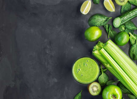 Fresh organic green smoothie with ingredients on gray concrete background. Top view. Copy space area.の写真素材