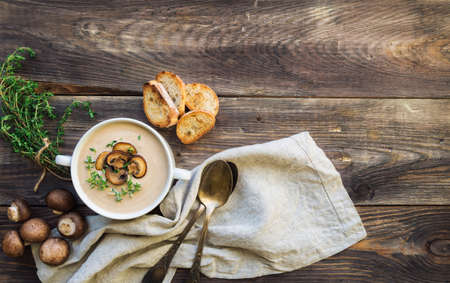 Creamy mushroom soup with champignons on rustic woodenの写真素材