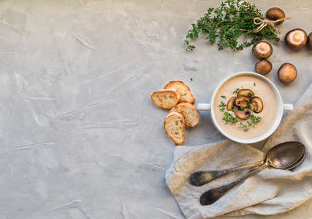 Creamy mushroom soup with champignons on light gray concreteの写真素材