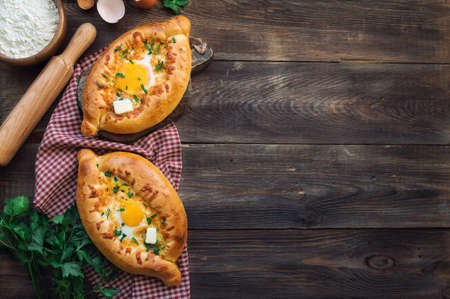 Fresh homemade khachapuri Ajarian on rustic woodenの写真素材