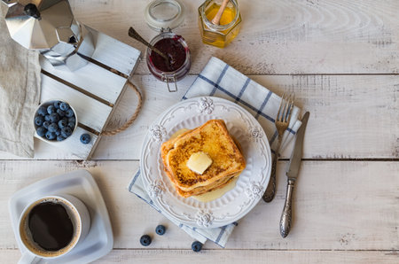 French toasts with butter and blueberries for breakfast. Top view.