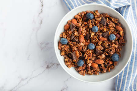 Homemade chocolate granola, muesli with almonds, hazelnuts and blueberries in bowlの写真素材