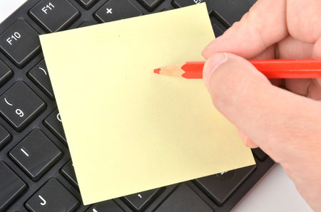 Post-it note ,keyboard and pencilの写真素材