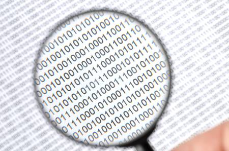Binary code and magnifierの写真素材