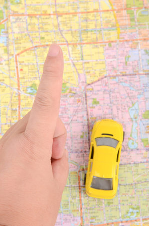 Toy car and map with finger
