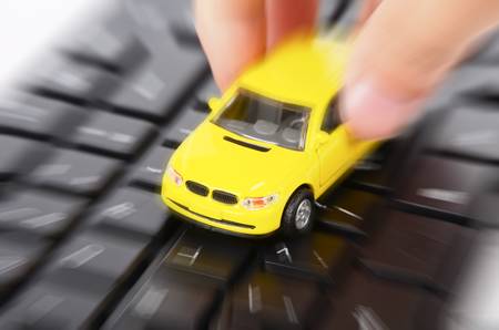 Toy car on keyboardの写真素材