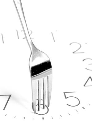 Fork on clock faceの写真素材
