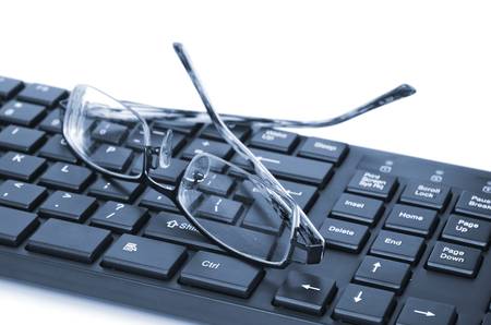 Computer keyboard and glassesの写真素材