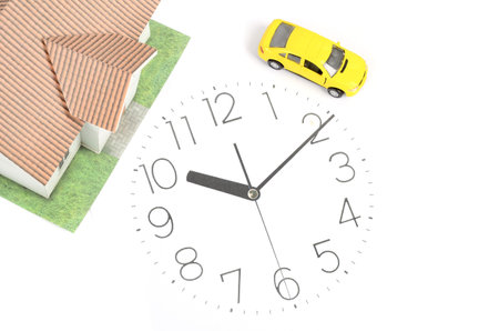 Toy car and house on clock face