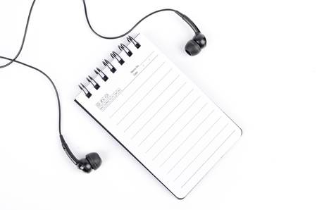 Notepad and earphoneの写真素材