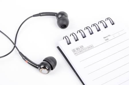 Notepad and earphoneの写真素材