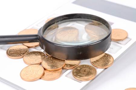 Calculator and magnifier with coinsの写真素材