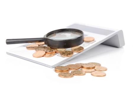 Calculator and magnifier with coinsの写真素材