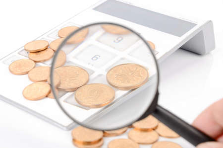 Calculator and magnifier with coinsの写真素材