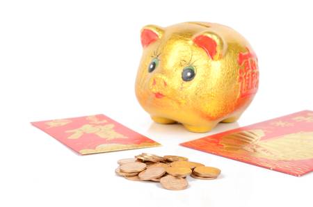 Piggy bank and red packet with coinsの写真素材
