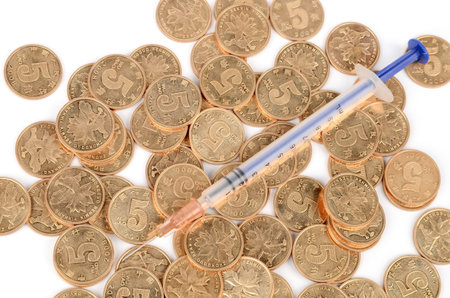 Coins and syringeの写真素材