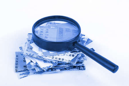 Wastepaper and magnifierの写真素材