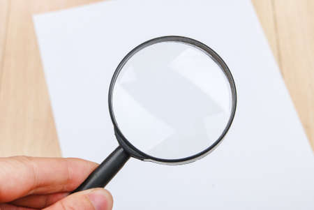 A4 paper and magnifierの写真素材