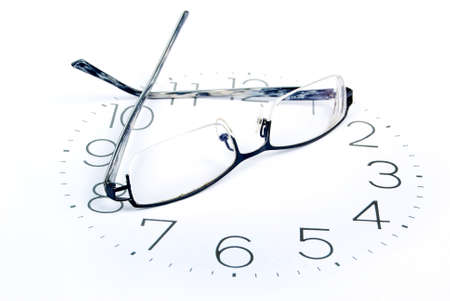 Eyeglasses and clockの写真素材