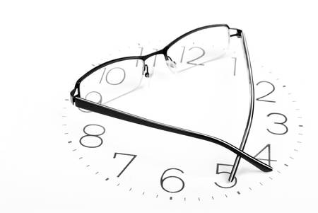 Eyeglasses and clockの写真素材