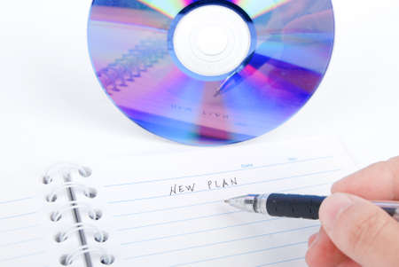 DVD and notepad with penの写真素材